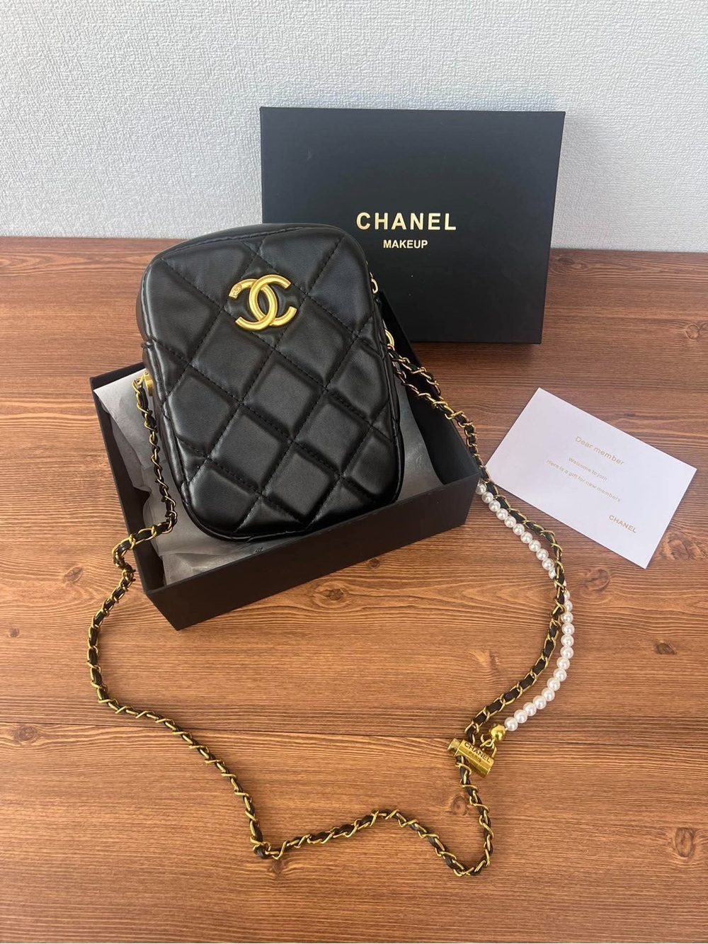CHANEL Black Quilted Crossbody Bag with Gold CC and Pearl-Accented Chain